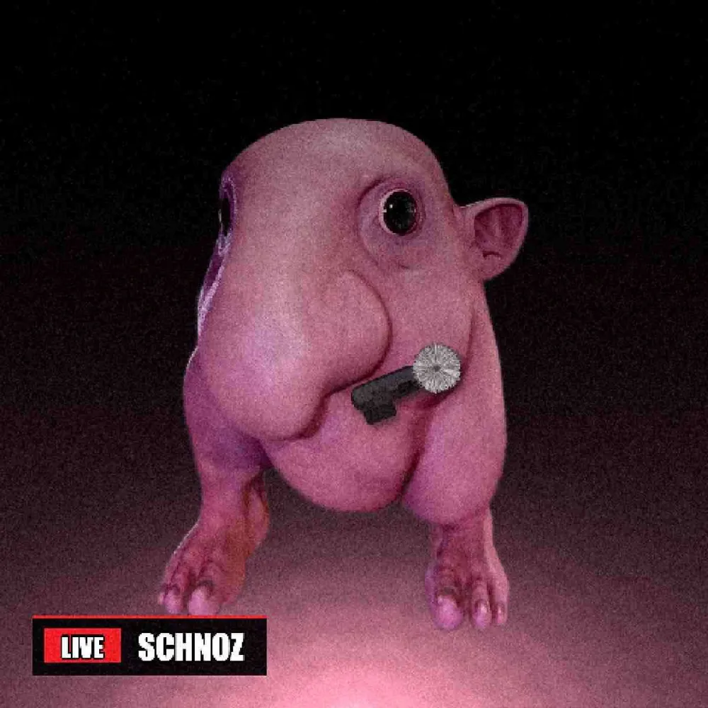 The creature over a floor-level camera with a lavalier microphone clipped to his cheek, under a LIVE news banner