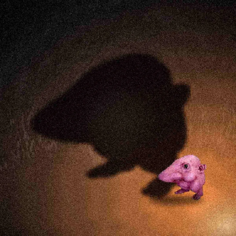 A small creature throwing an enormous shadow on a wall